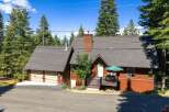 Nestled amidst towering pine trees, this charming mountain home offers a serene retreat.
