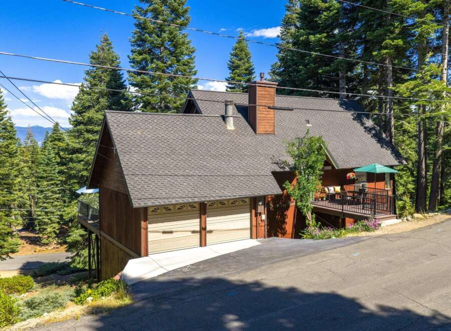 Nestled amidst towering pine trees, this charming mountain home offers a serene retreat.