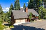 Nestled amidst towering pine trees, this charming mountain home offers a serene retreat.
