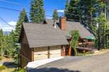 Nestled amidst towering pine trees, this charming mountain home offers a serene escape.