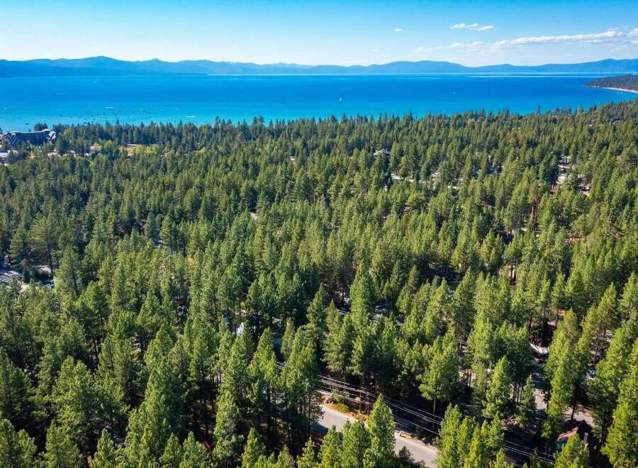 Experience the serene beauty of Lake Tahoe from this stunning property nestled amidst a lush pine forest.