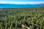 Experience the serene beauty of Lake Tahoe from this stunning property nestled amidst a lush pine forest.
