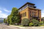 Experience urban living in this stunning multi-story building featuring a striking terracotta facade and a modern rooftop addition.