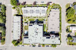 Discover this stunning aerial view of a modern apartment complex featuring multiple buildings with flat roofs and numerous HVAC units.