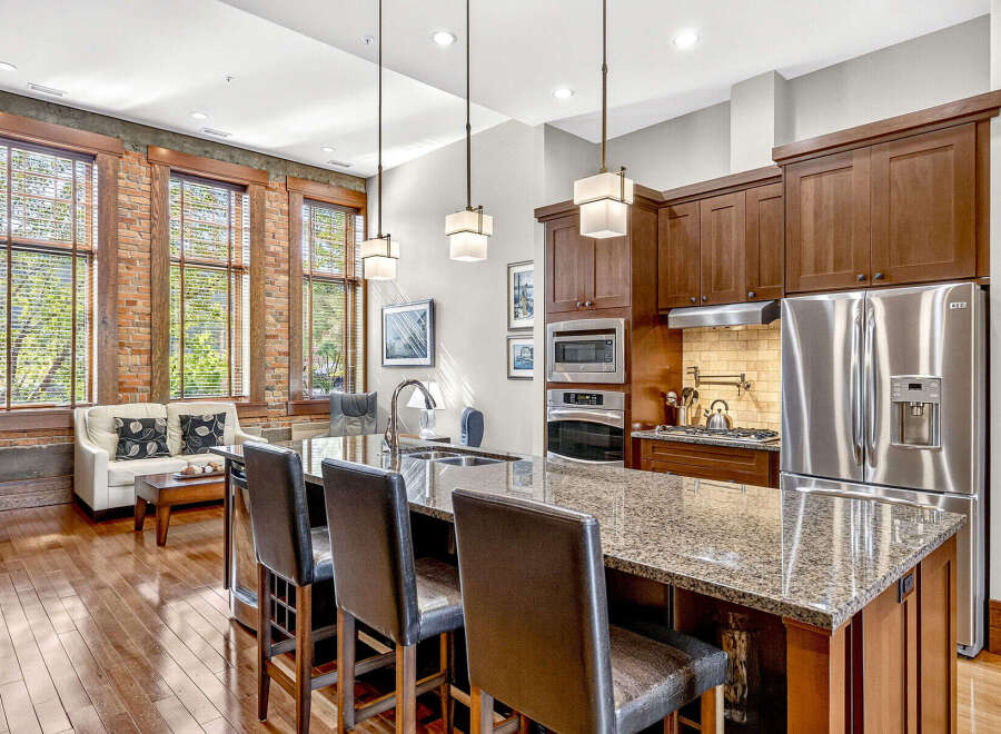 Experience urban living in this stunning loft-style condo featuring exposed brick walls and large windows that flood the space with natural light.