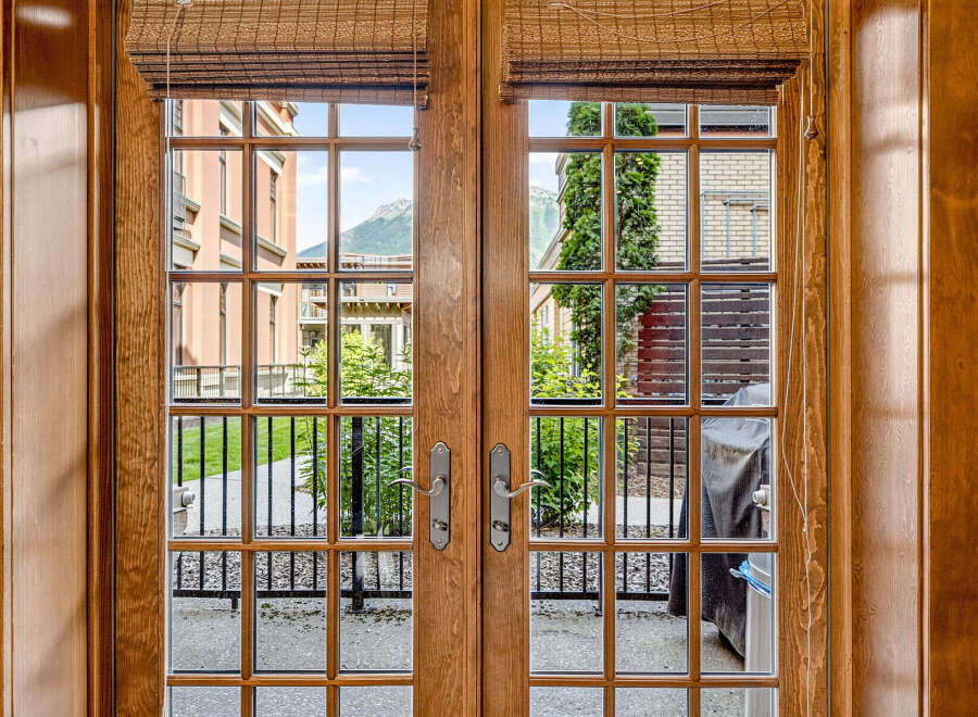 Step outside through these elegant French doors to a charming patio area, perfect for enjoying the fresh air and mountain views.