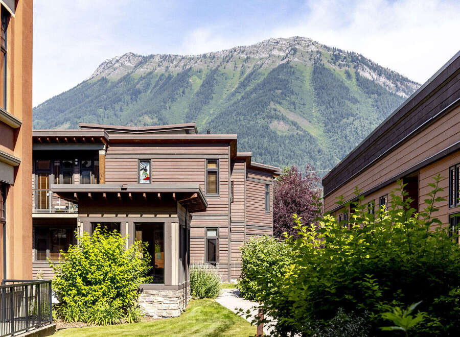 Experience modern living nestled against a majestic mountain backdrop.