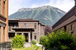 Experience modern living nestled against a majestic mountain backdrop.