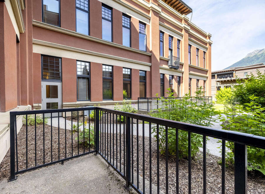 Experience modern living in this stunning property featuring a beautiful brick exterior and large windows that flood the interior with natural light.