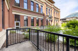 Experience modern living in this stunning property featuring a beautiful brick exterior and large windows that flood the interior with natural light.