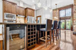 Experience luxury living in this stunning kitchen featuring rich wood cabinetry and a sleek granite countertop.