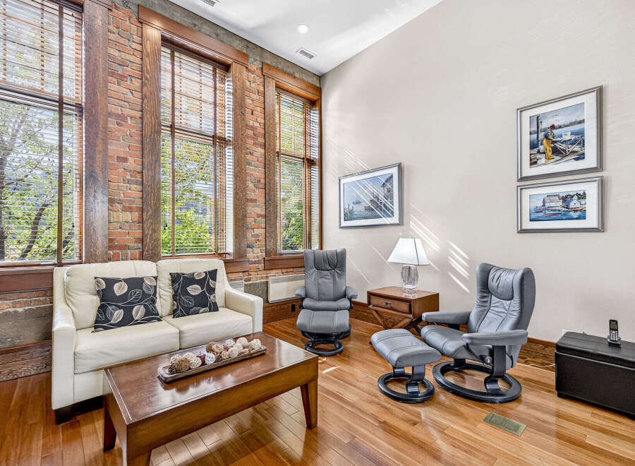 Experience urban living in this stunning loft featuring exposed brick walls and large windows that flood the space with natural light.