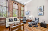 Experience urban living in this stunning loft featuring exposed brick walls and large windows that flood the space with natural light.