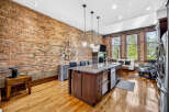 Experience urban living in this stunning loft featuring exposed brick walls and gleaming hardwood floors.
