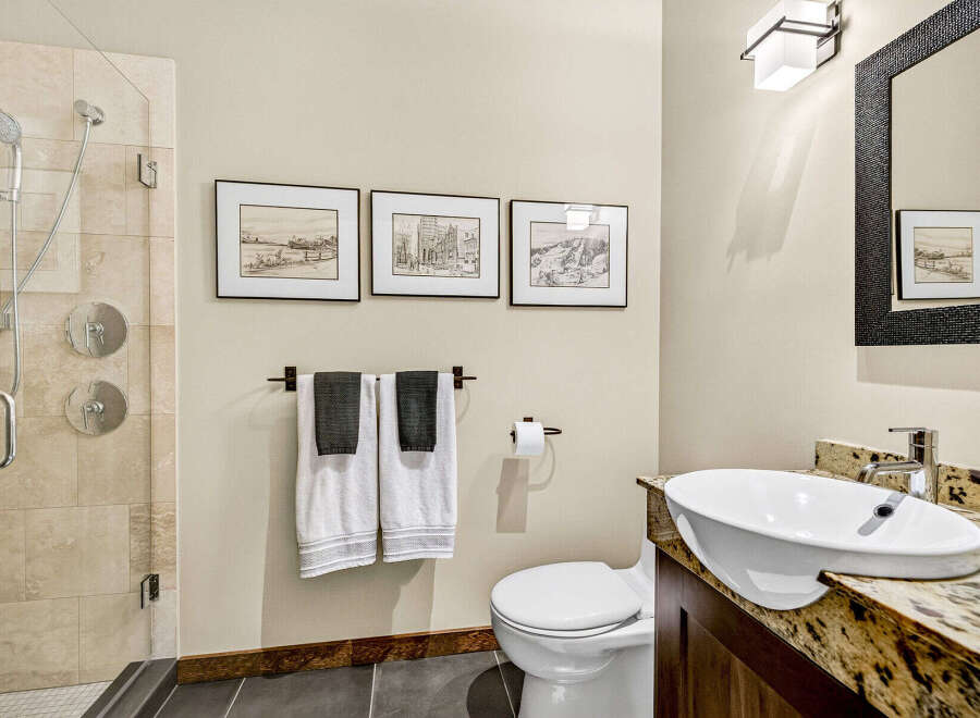 This modern bathroom features a sleek walk-in shower with dual shower heads and elegant tile work.