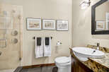 This modern bathroom features a sleek walk-in shower with dual shower heads and elegant tile work.