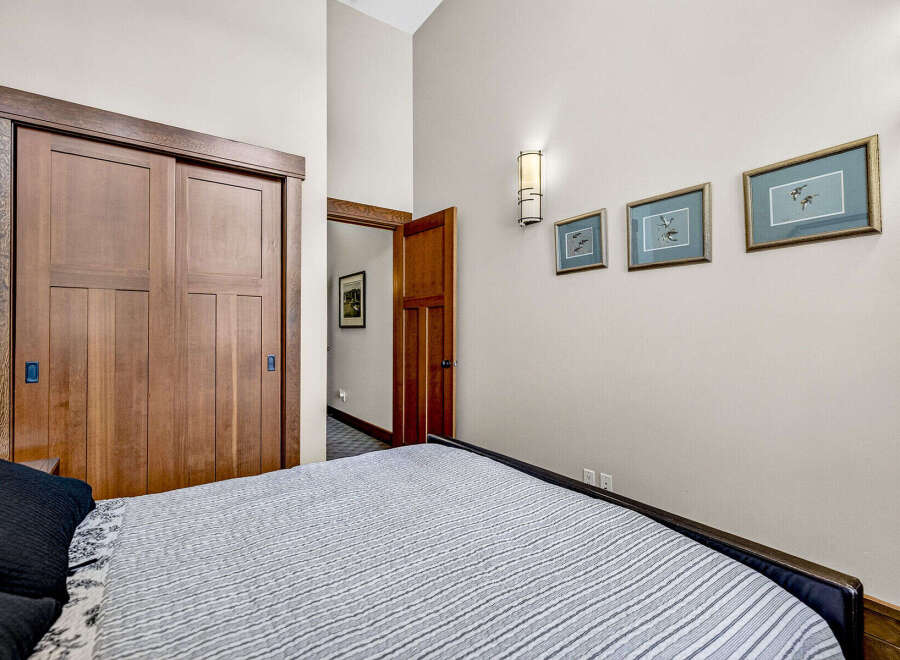 This bedroom features a spacious closet with beautiful wooden sliding doors, adding a touch of natural warmth to the space.