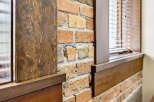 Experience rustic charm with this exposed brick wall, complemented by rich wooden accents.