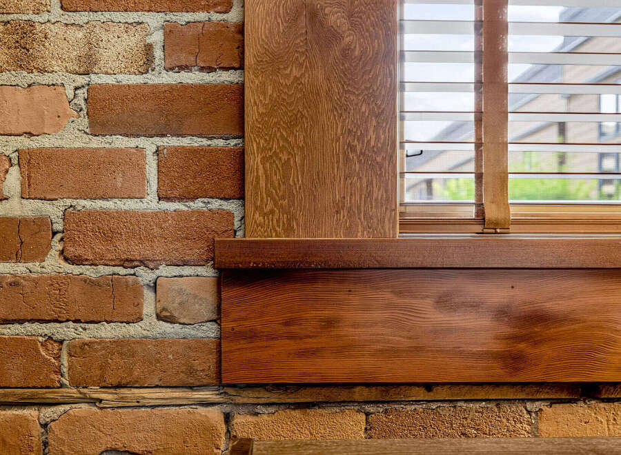 Experience rustic charm with exposed brick walls complemented by warm, natural wood accents.
