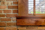 Experience rustic charm with exposed brick walls complemented by warm, natural wood accents.