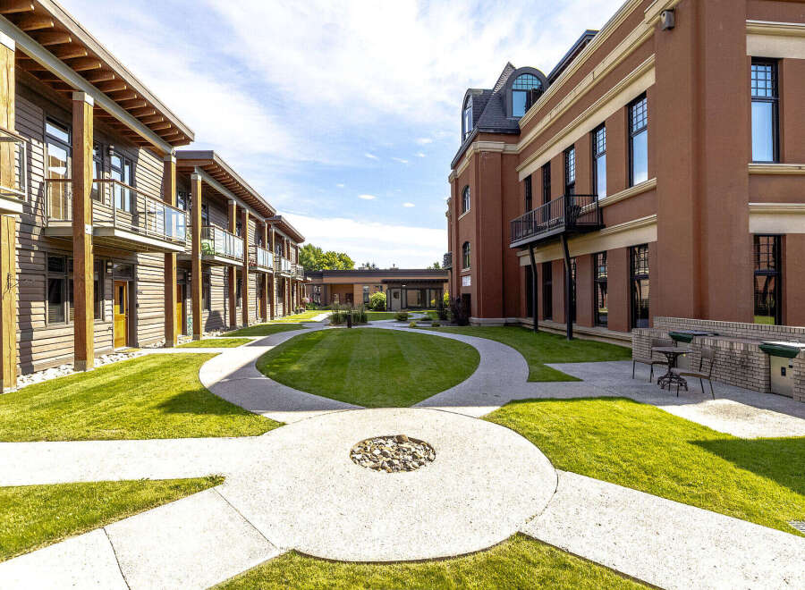 Discover modern living in this beautifully designed courtyard featuring contemporary architecture with wood and brick facades.