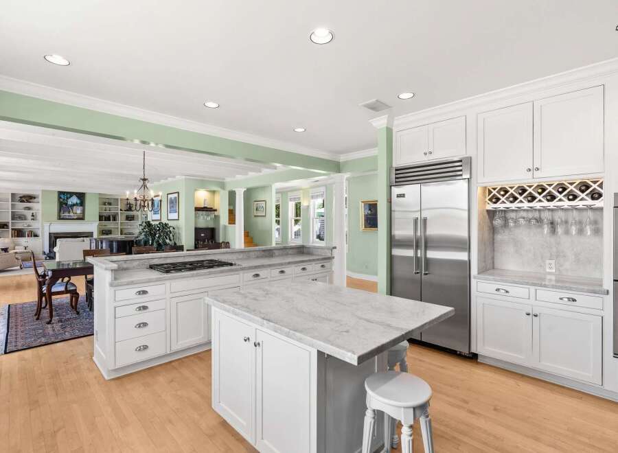 Experience luxury living in this stunning kitchen, featuring a spacious marble island perfect for meal prep and casual dining.