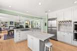 Experience luxury living in this stunning kitchen, featuring a spacious marble island perfect for meal prep and casual dining.