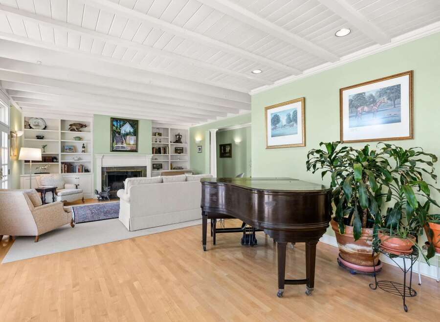 This inviting living room features a grand piano, perfect for musical enthusiasts.