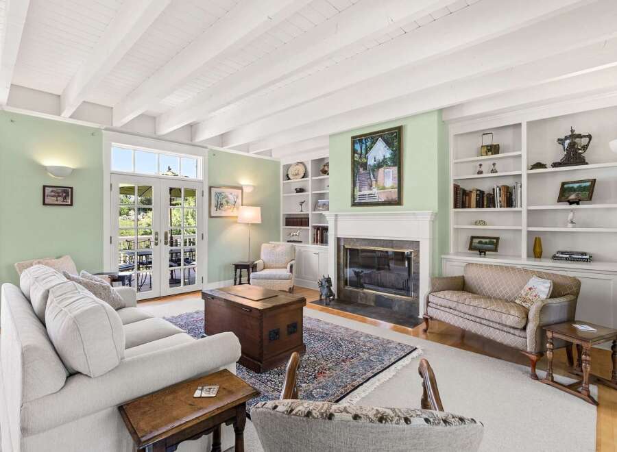 This inviting living room features a charming fireplace with built-in bookshelves, perfect for displaying your favorite decor.