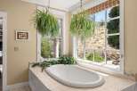 Indulge in relaxation in this stunning bathroom featuring a luxurious freestanding bathtub.