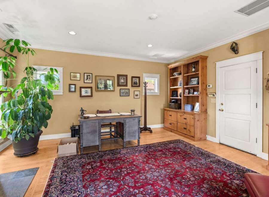 This home office features a large, ornate rug and a classic wooden desk, perfect for a productive workday.