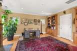 This home office features a large, ornate rug and a classic wooden desk, perfect for a productive workday.
