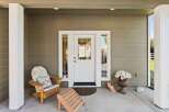 Welcome guests to this charming home with a covered front porch, perfect for enjoying your morning coffee.
