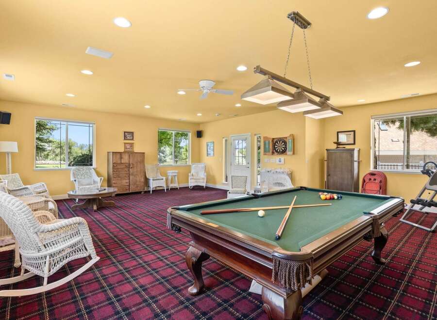 Enjoy endless entertainment in this spacious game room, featuring a classic pool table perfect for friendly competitions.