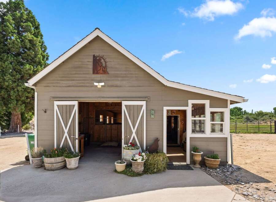 Discover this charming barn with a rustic aesthetic, featuring double sliding doors that open into a spacious interior.
