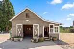 Discover this charming barn with a rustic aesthetic, featuring double sliding doors that open into a spacious interior.