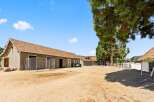 Discover this charming equestrian property featuring a spacious barn with multiple stalls and ample storage.
