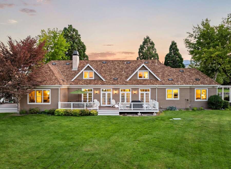 This charming home features a spacious backyard with a large deck perfect for entertaining.