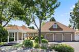This charming home features a welcoming covered porch with white columns, leading to a spacious interior.