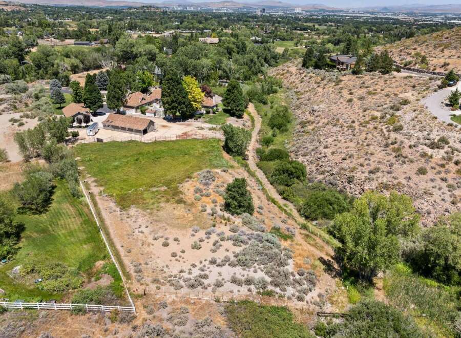 Discover this expansive property offering a blend of manicured lawns and natural desert landscaping, perfect for those seeking space and tranquility.