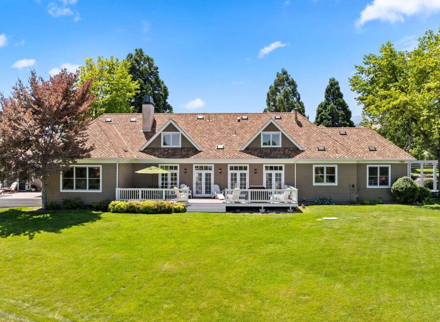 This expansive home features a beautiful backyard with a large deck perfect for entertaining.