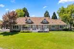 This expansive home features a beautiful backyard with a large deck perfect for entertaining.