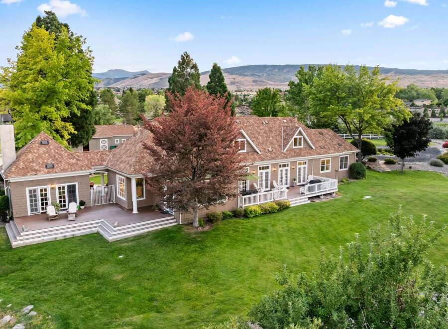 Discover this stunning property featuring a spacious multi-level deck perfect for entertaining, overlooking a beautifully manicured lawn and mature trees.