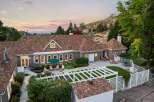 Experience luxury living in this stunning home, featuring a spacious backyard with a white pergola and ample seating areas perfect for entertaining.