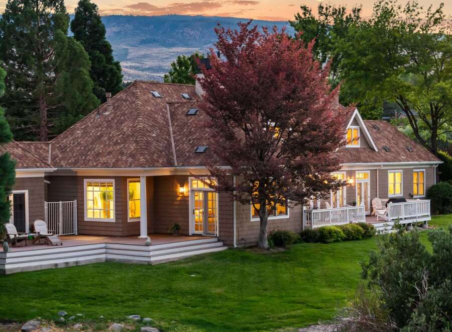 This charming home features a spacious wrap-around deck perfect for outdoor entertaining and enjoying the serene sunset views.