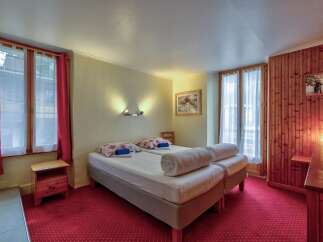 This charming hotel room features two comfortable twin beds, perfect for solo travelers or friends.