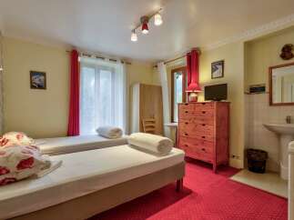 This charming hotel room features two comfortable twin beds, perfect for solo travelers or friends.