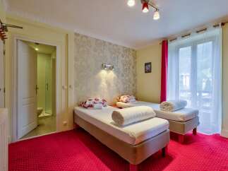 This charming hotel room features two comfortable twin beds, perfect for solo travelers or friends.