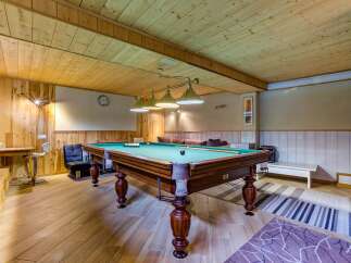 Experience ultimate relaxation and entertainment in this beautifully appointed game room, featuring a classic billiard table as its centerpiece.