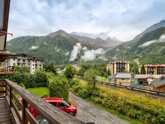 Experience breathtaking mountain views from this charming property, nestled amidst lush greenery and towering peaks.